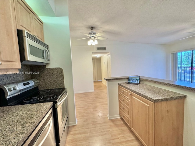 kitchen featuring ceiling fan, stainless steel appliances, light hardwood / wood-style floors, and light brown cabinets