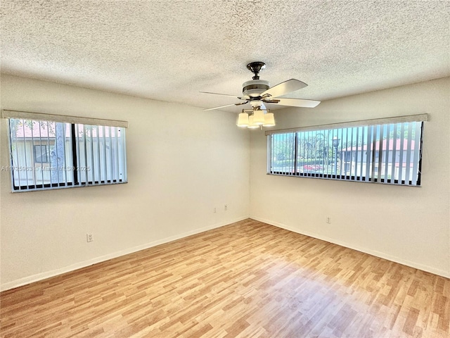 empty room featuring hardwood / wood-style floors, a textured ceiling, and ceiling fan