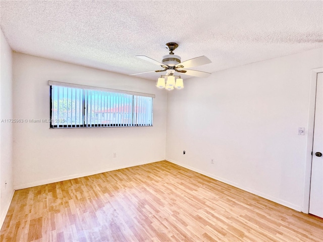 unfurnished room featuring ceiling fan, wood-type flooring, and a textured ceiling