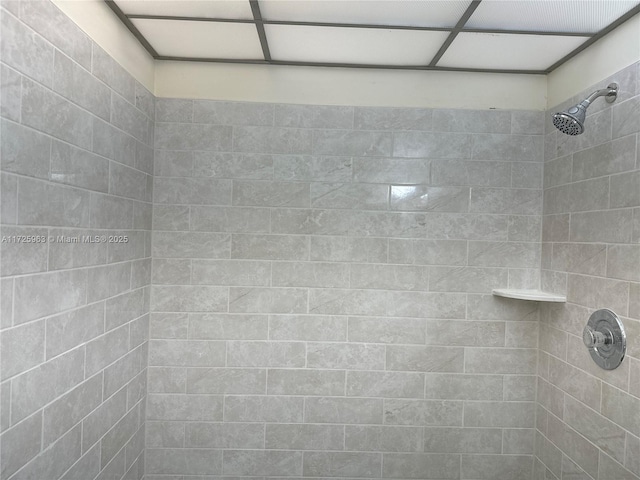 bathroom with a tile shower