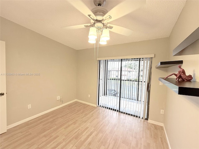 unfurnished room with ceiling fan, light hardwood / wood-style flooring, and a textured ceiling