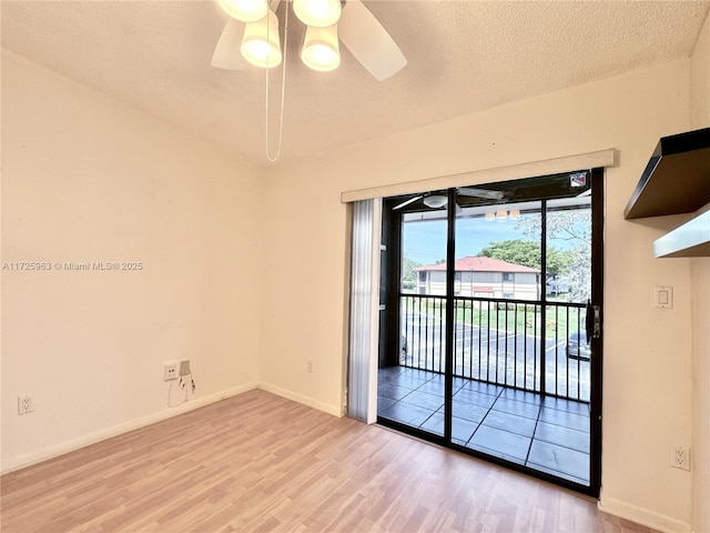 unfurnished room with ceiling fan, light hardwood / wood-style flooring, and a textured ceiling