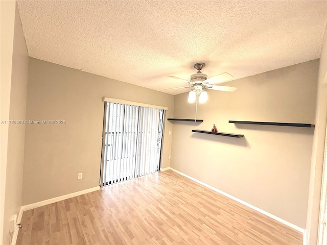 spare room featuring a textured ceiling, ceiling fan, and light wood-type flooring