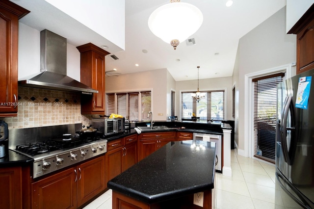 kitchen featuring light tile patterned floors, visible vents, decorative backsplash, wall chimney exhaust hood, and stainless steel appliances