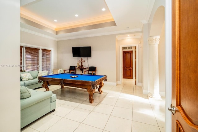 game room featuring arched walkways, a tray ceiling, decorative columns, and crown molding