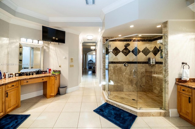 full bathroom with tile patterned flooring, crown molding, a shower stall, and vanity