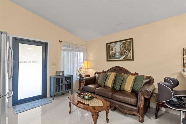 tiled living room featuring vaulted ceiling and a textured ceiling