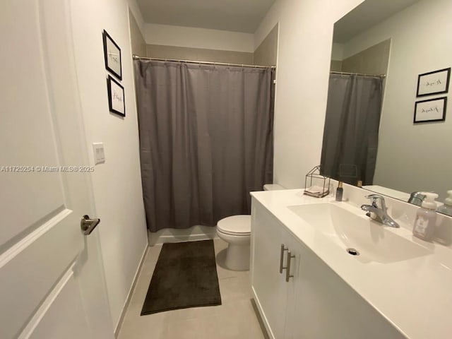 bathroom featuring vanity, a shower with curtain, tile patterned floors, and toilet