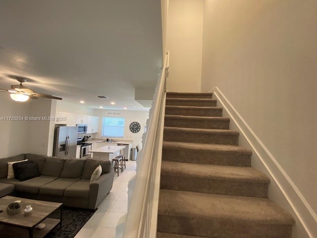 stairs with tile patterned flooring and ceiling fan