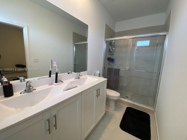 bathroom featuring toilet, a shower with door, tile patterned flooring, and vanity