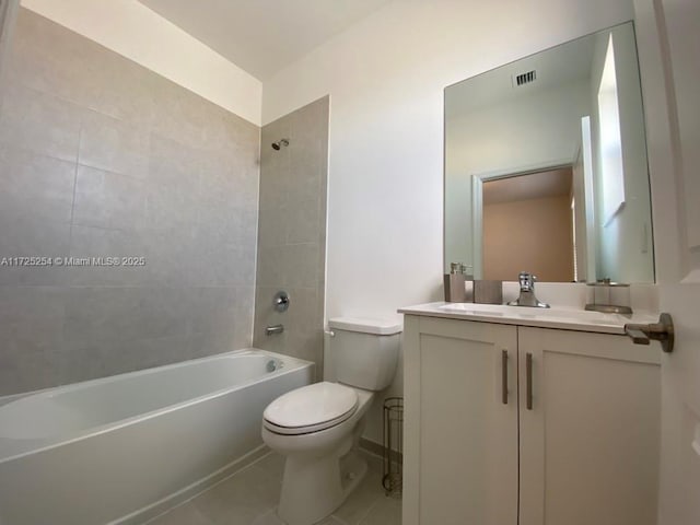 full bathroom with tiled shower / bath, vanity, tile patterned floors, and toilet