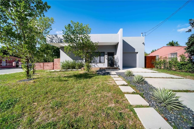 view of front of property with a front yard and a garage