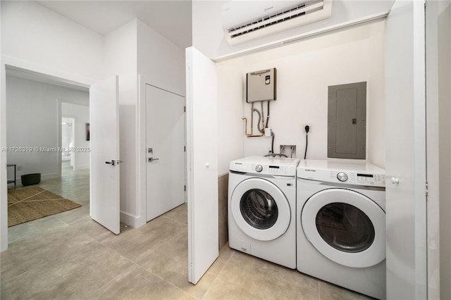 laundry room featuring a wall mounted AC, washing machine and dryer, and electric panel