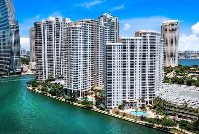 exterior space with a city view and a water view