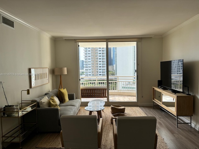 living room featuring a wall of windows, visible vents, wood finished floors, and crown molding