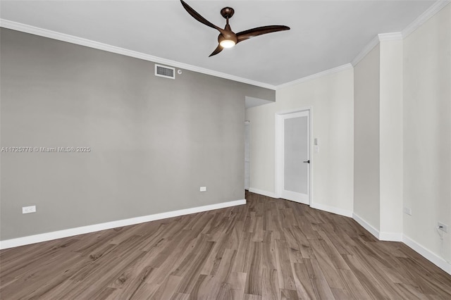 unfurnished room with baseboards, crown molding, ceiling fan, and wood finished floors