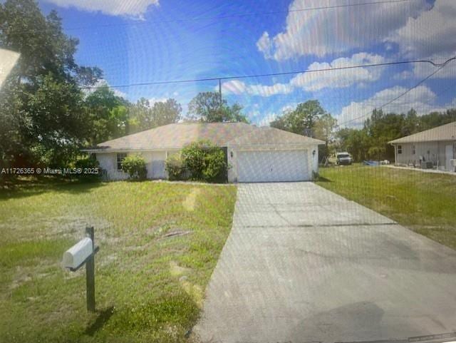 view of front of property featuring a garage and a front lawn