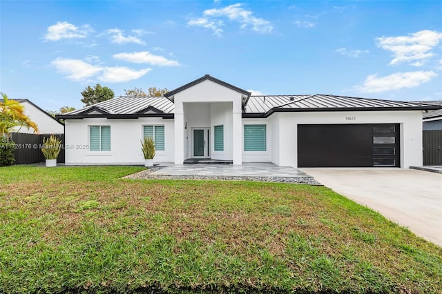 view of front of house with a garage and a front lawn