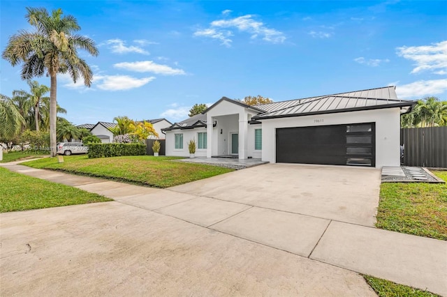 view of front of home featuring a front yard and a garage