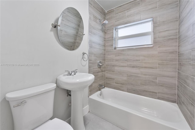 full bathroom featuring toilet, sink, and tiled shower / bath