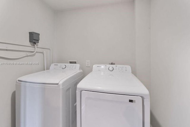 clothes washing area with washer and dryer