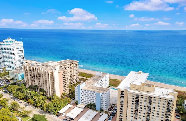 drone / aerial view with a beach view and a water view