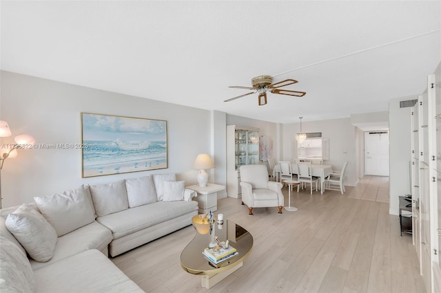 living room with light wood-type flooring and ceiling fan