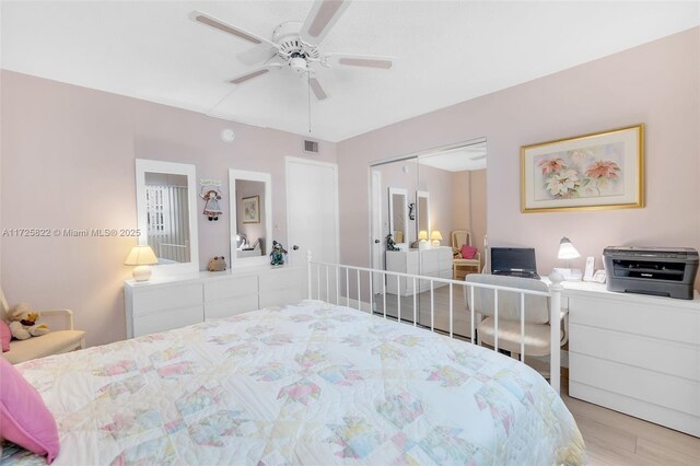 bedroom with a closet, ceiling fan, and light wood-type flooring