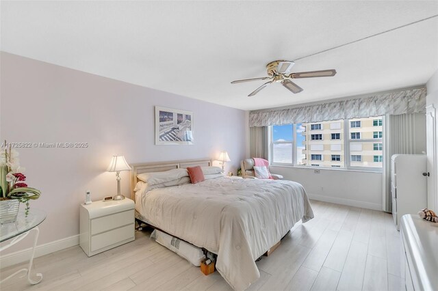 bedroom featuring ceiling fan and light hardwood / wood-style floors