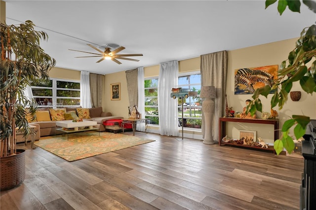 living room with wood-type flooring and ceiling fan