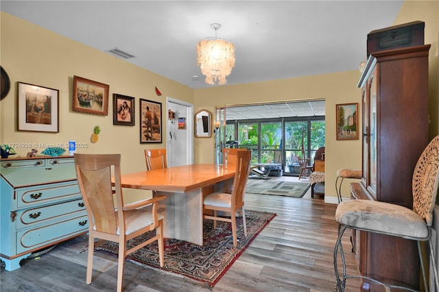 dining space with a chandelier and hardwood / wood-style floors