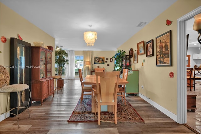 dining area featuring a chandelier and dark hardwood / wood-style floors