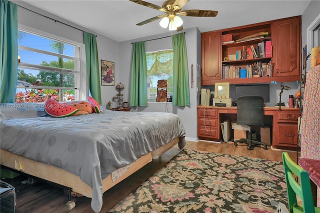 bedroom with ceiling fan and light hardwood / wood-style flooring