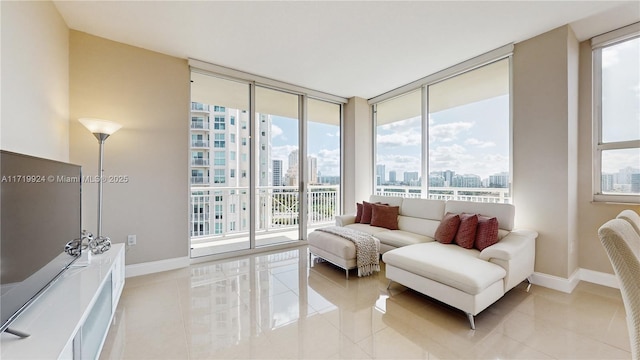 sitting room with floor to ceiling windows and light tile patterned flooring