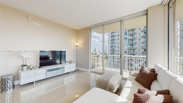 living room featuring light tile patterned floors and expansive windows