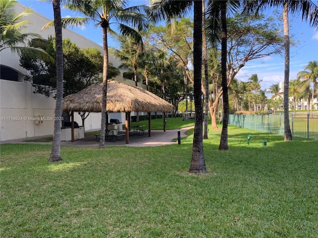 view of property's community featuring a water view, a gazebo, and a lawn