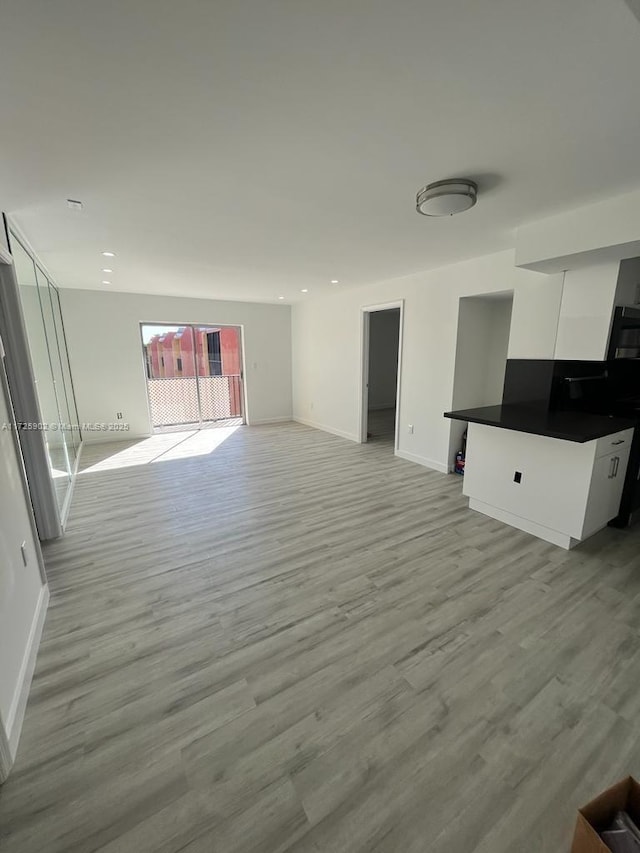 unfurnished living room with light wood-type flooring