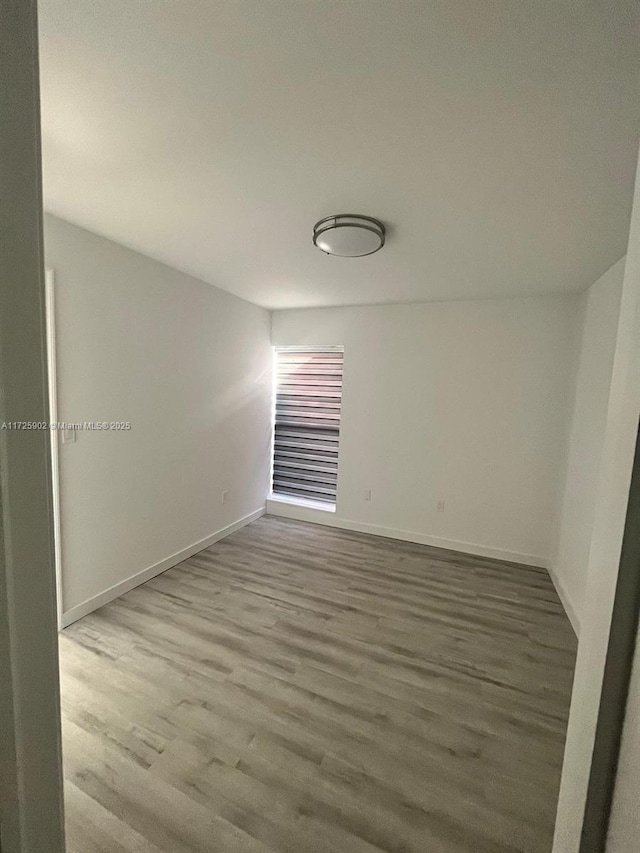 spare room featuring hardwood / wood-style flooring