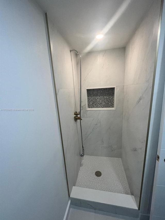 bathroom with a tile shower