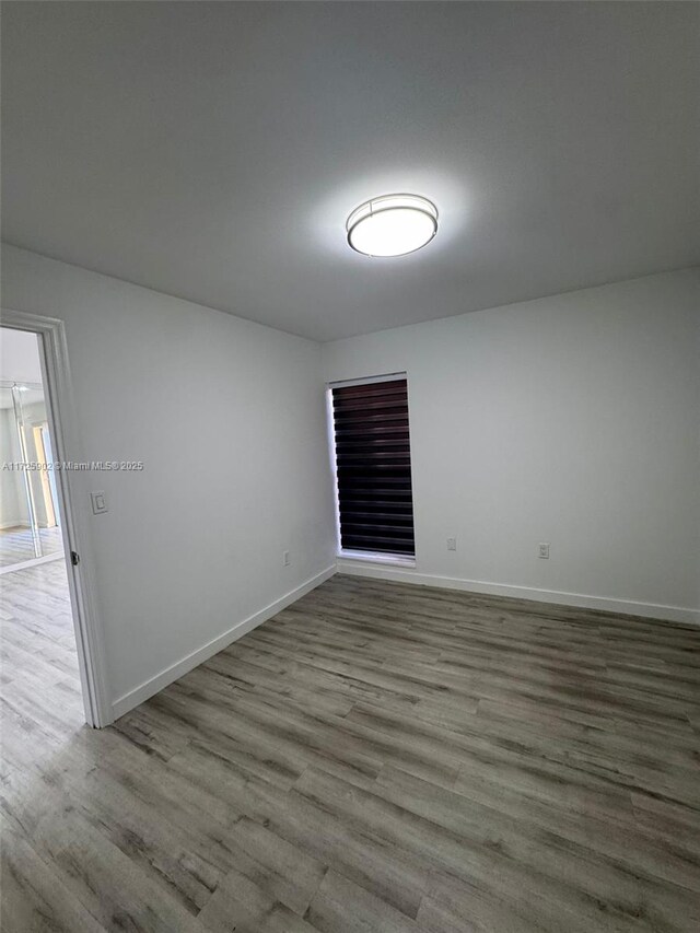 unfurnished room featuring wood-type flooring