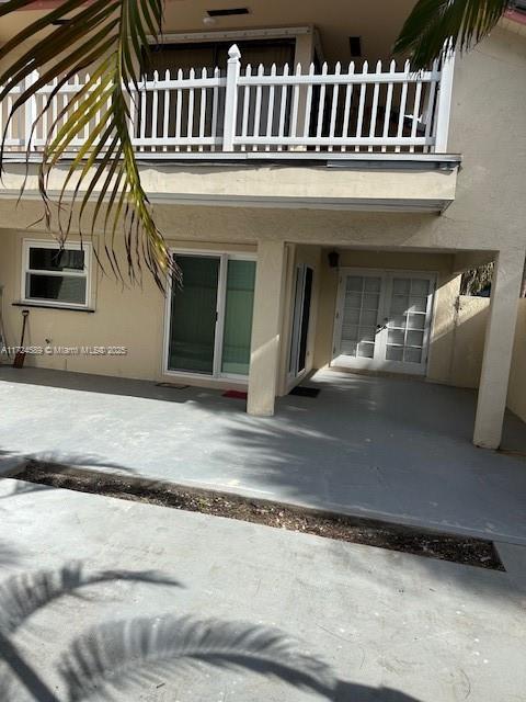 doorway to property featuring a balcony and a patio area