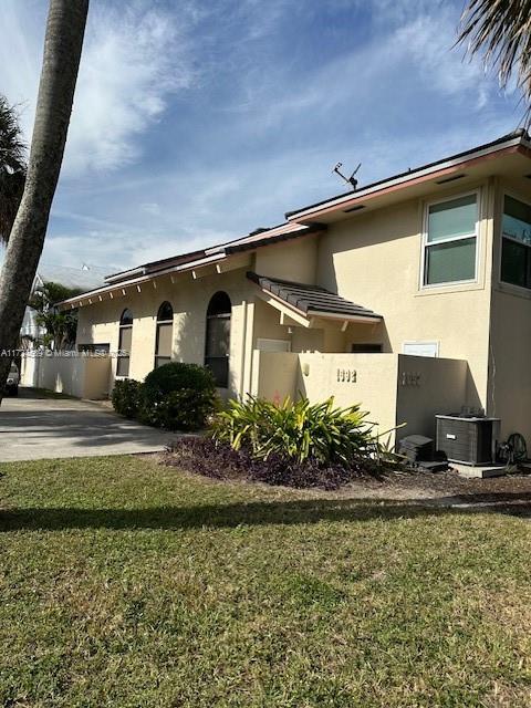 view of home's exterior featuring central air condition unit, a patio area, and a yard