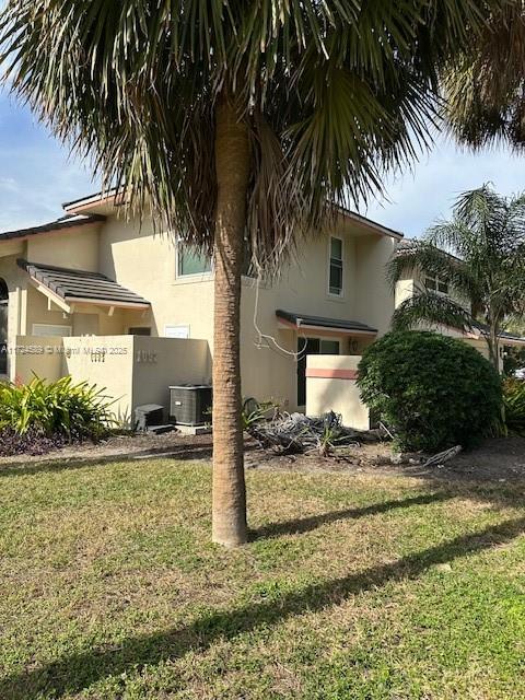 view of property exterior with a yard