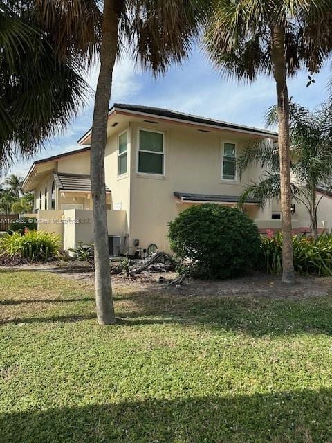 view of side of home featuring a lawn