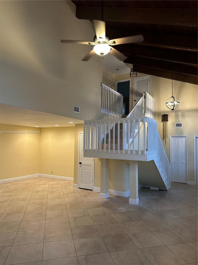 stairs featuring high vaulted ceiling, ceiling fan, and tile patterned flooring