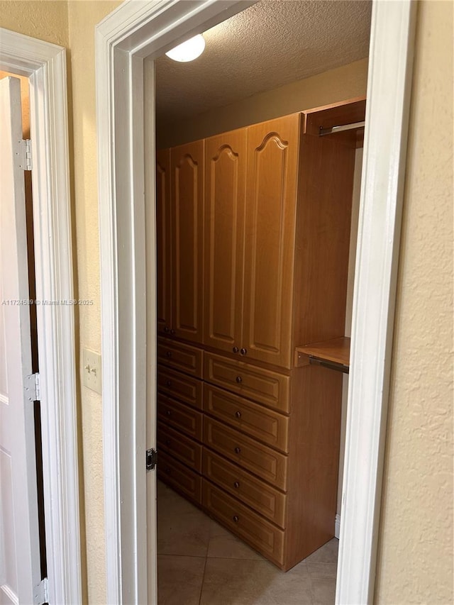 spacious closet featuring light tile patterned flooring