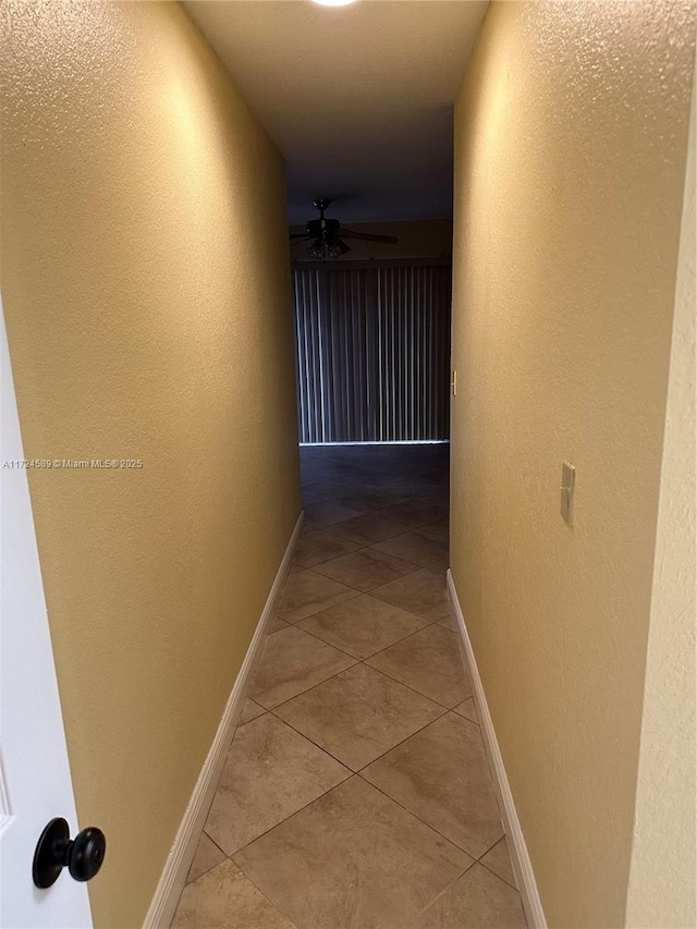 corridor featuring light tile patterned floors