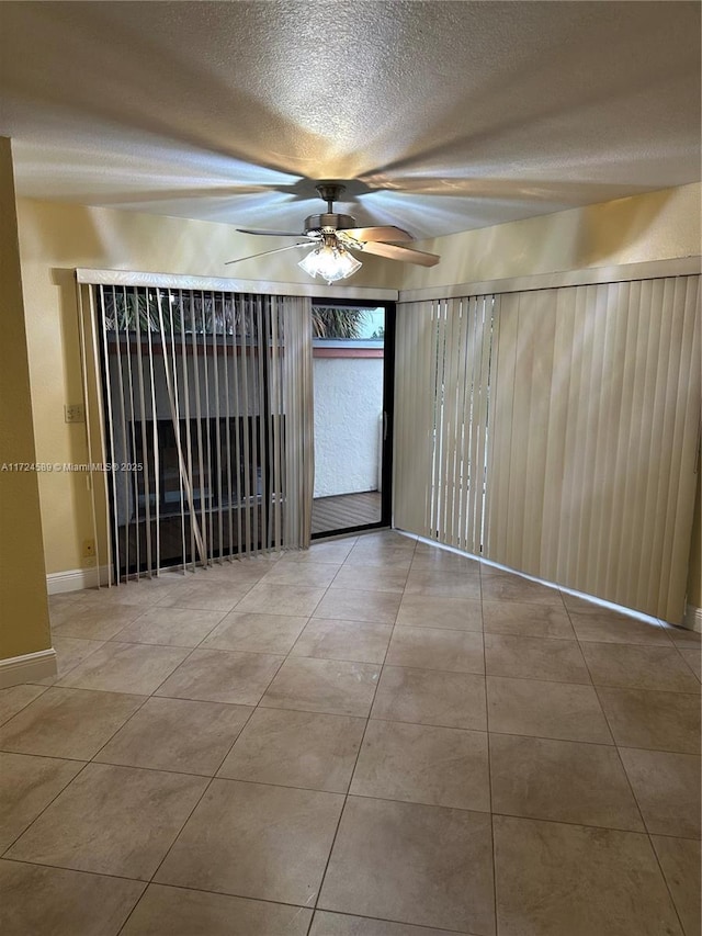 unfurnished room featuring ceiling fan and light tile patterned flooring