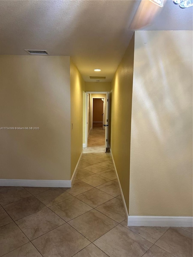 corridor featuring light tile patterned flooring