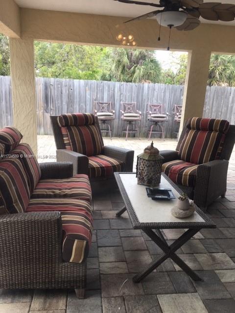 view of patio / terrace featuring ceiling fan and an outdoor living space